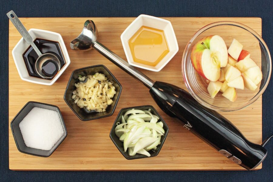 Schälchen mit Sojasoße, Sesamöl, Knoblauch, Zucker und Zwiebel, Apfelstücke und ein Pürierstab